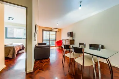 a room with a bed and a table and chairs at Viaggiato Larrañaga II in Cordoba