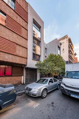 two cars parked in a parking lot next to a building at Viaggiato Larrañaga II in Cordoba