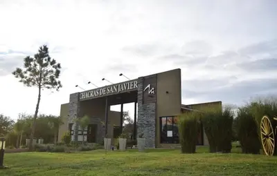 a building with a sign on it in a field at La Peperina in San Javier