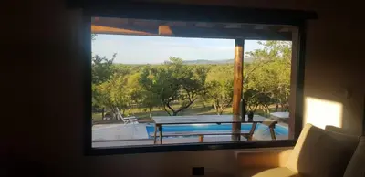 a window with a view of a table and a pool at La Peperina in San Javier