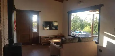 a living room with a couch and a large window at La Peperina in San Javier