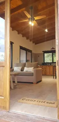 a living room with a couch and a ceiling fan at La Peperina in San Javier