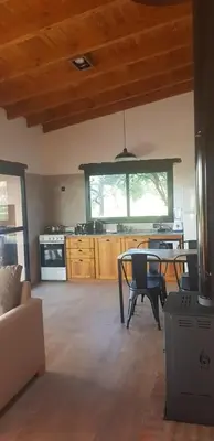 a living room with a table and a kitchen at La Peperina in San Javier