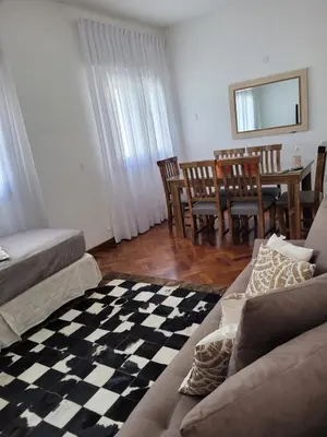 a living room with a couch and a table and chairs at Departamento céntrico y espacioso en Río Cuarto. in Río Cuarto