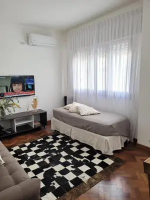 a bedroom with a bed and a checkered floor at Departamento céntrico y espacioso en Río Cuarto. in Río Cuarto