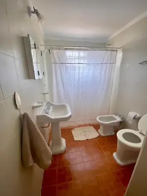 a bathroom with a sink and a toilet at La Casita de la Villa in Villa Carlos Paz