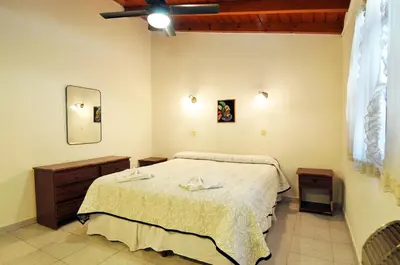 a bedroom with a bed and a mirror at Aranjuez Real in Villa Carlos Paz