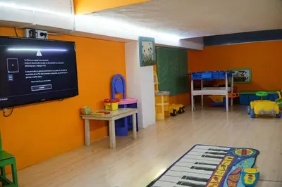 a room with a flat screen tv and a room with toys at Aranjuez Real in Villa Carlos Paz