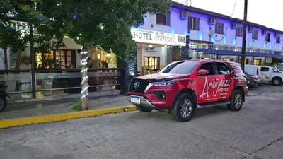 a red suv parked on the side of a street at Aranjuez Real in Villa Carlos Paz