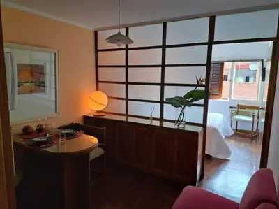 a living room with a table and a bedroom at Departamento de lujo en Cordoba Capital in Cordoba