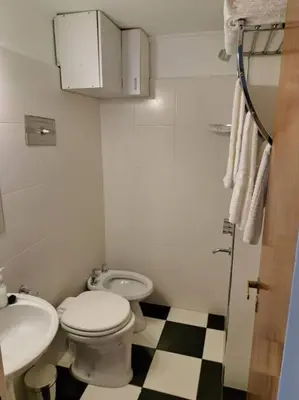 a bathroom with a toilet and a sink at Departamento de lujo en Cordoba Capital in Cordoba