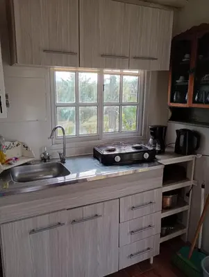 a kitchen counter with a sink and a window at Cabañas Don Fernando in Santa Rosa de Calamuchita