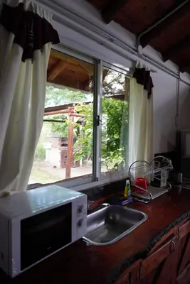 a kitchen counter with a sink and a window at Cabañas Don Fernando in Santa Rosa de Calamuchita