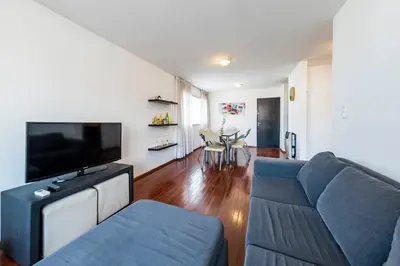 a living room with a blue couch and a flat screen tv at Lima 823 B General Paz in Cordoba