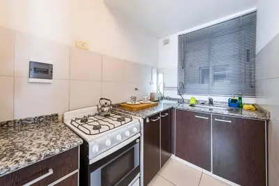 a kitchen with a stove top oven next to a sink at Lima 823 B General Paz in Cordoba