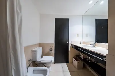 a bathroom with a toilet and a sink and a mirror at Lima 823 B General Paz in Cordoba