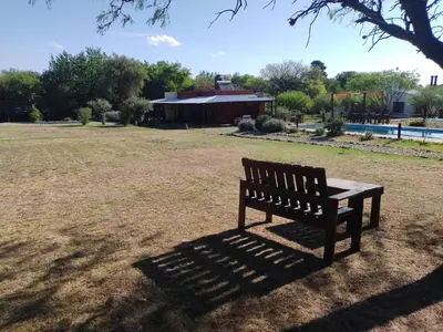 a park bench sitting in the middle of a field at Cielos Abiertos in La Paz