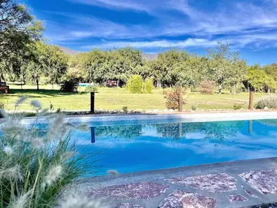 a swimming pool with blue water in a yard at Cielos Abiertos in La Paz