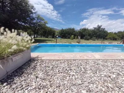 a swimming pool in a gravel yard with a blue at Cielos Abiertos in La Paz