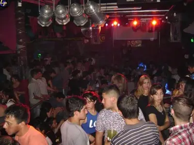 a group of people standing in a crowd in a bar at Cielos Abiertos in La Paz