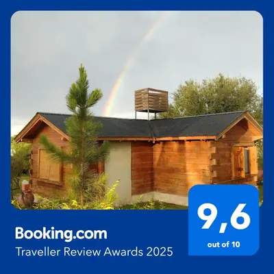 a rainbow over a house with a house at Cabaña en Villa Amancay in Villa Amancay