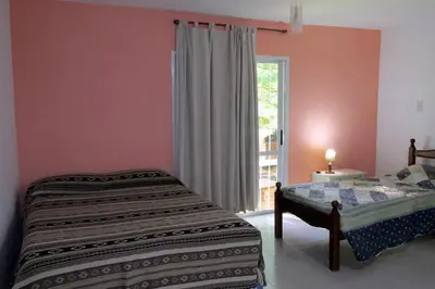 a bedroom with two beds and a window at LUNA CAUTIVA in Santa Rosa de Calamuchita