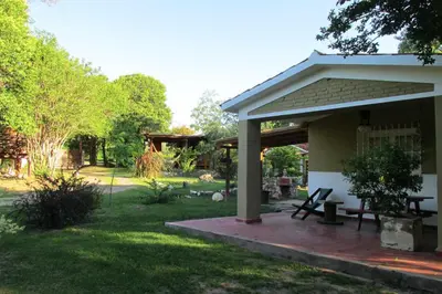 a porch of a house with a picnic table at LUNA CAUTIVA in Santa Rosa de Calamuchita