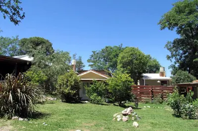 a yard with some sheep laying in the grass at LUNA CAUTIVA in Santa Rosa de Calamuchita