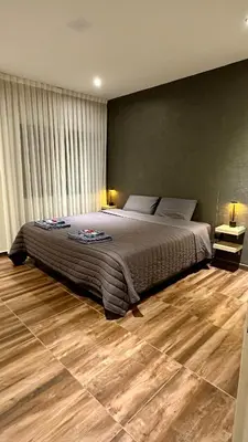 a bedroom with a large bed and a wooden floor at Atlantico in Cordoba