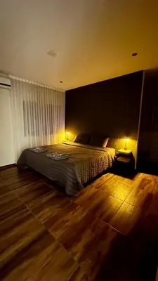 a bedroom with a bed with two lights on it at Atlantico in Cordoba