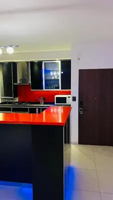 a kitchen with a red counter top in a room at Atlantico in Cordoba