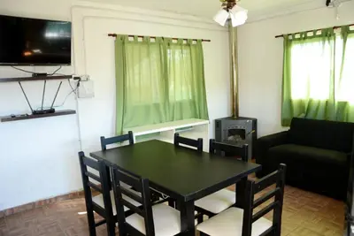 a living room with a table and a couch at Potrero de Garay in Potrero de Garay