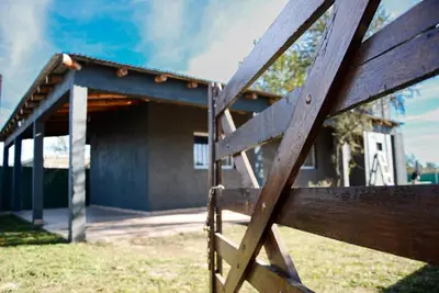 a wooden fence in front of a building at Potrero de Garay in Potrero de Garay