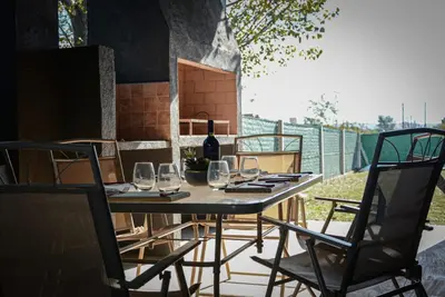 a table with wine glasses and a bottle of wine at Potrero de Garay in Potrero de Garay