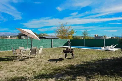 a table and chairs with an umbrella next to a pool at Potrero de Garay in Potrero de Garay