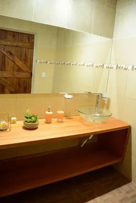 a bathroom counter with a sink and a mirror at Potrero de Garay in Potrero de Garay