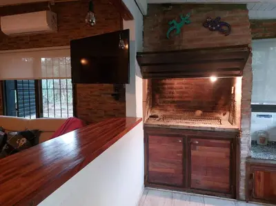 a kitchen with a large fish tank in a room at Cardozo House, casa de campo in Villa Dolores