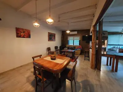 a living room with a wooden table and chairs at Cardozo House, casa de campo in Villa Dolores