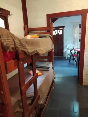 a group of bunk beds in a room at Los Moradillos Cabañas in Santa Rosa de Calamuchita