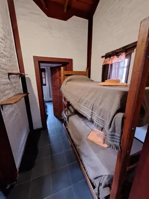 a bedroom with a bunk bed in a house at Los Moradillos Cabañas in Santa Rosa de Calamuchita