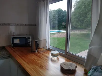 a kitchen counter with a microwave and a window at Cabañas Matilda in Los Molles
