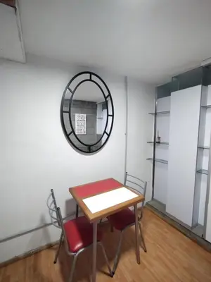 a table and chairs in a room with a mirror at Duplex-Loft in Cordoba
