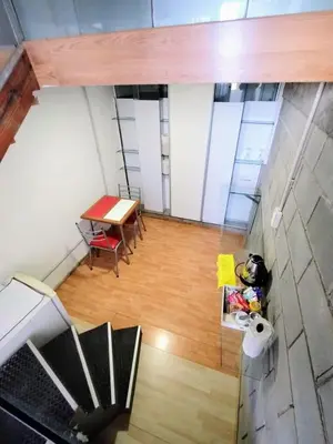 an overhead view of a room with a table and a wooden floor at Duplex-Loft in Cordoba