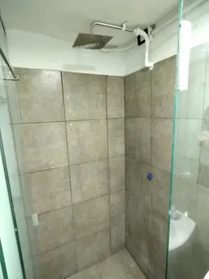 a shower with a glass door and a sink at Duplex-Loft in Cordoba
