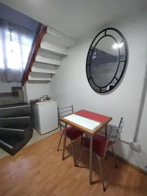 a table and chairs in a room with a mirror at Duplex-Loft in Cordoba
