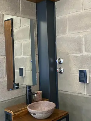 a bathroom sink with a mirror and a bowl at Departamento pleno centro costanera estilo industrial único in Santa Rosa de Calamuchita