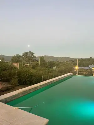 a swimming pool with green water in the middle at CHALET DE SIQUIMAN in Villa Parque Siquiman