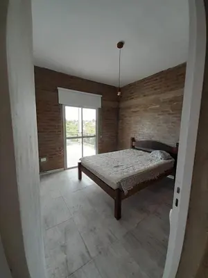 a bedroom with a bed and a large window at CHALET DE SIQUIMAN in Villa Parque Siquiman