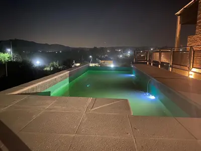 a swimming pool on top of a building at night at CHALET DE SIQUIMAN in Villa Parque Siquiman
