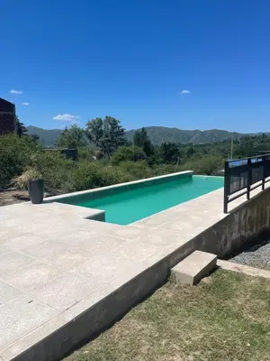 a swimming pool with a bench next to it at CHALET DE SIQUIMAN in Villa Parque Siquiman
